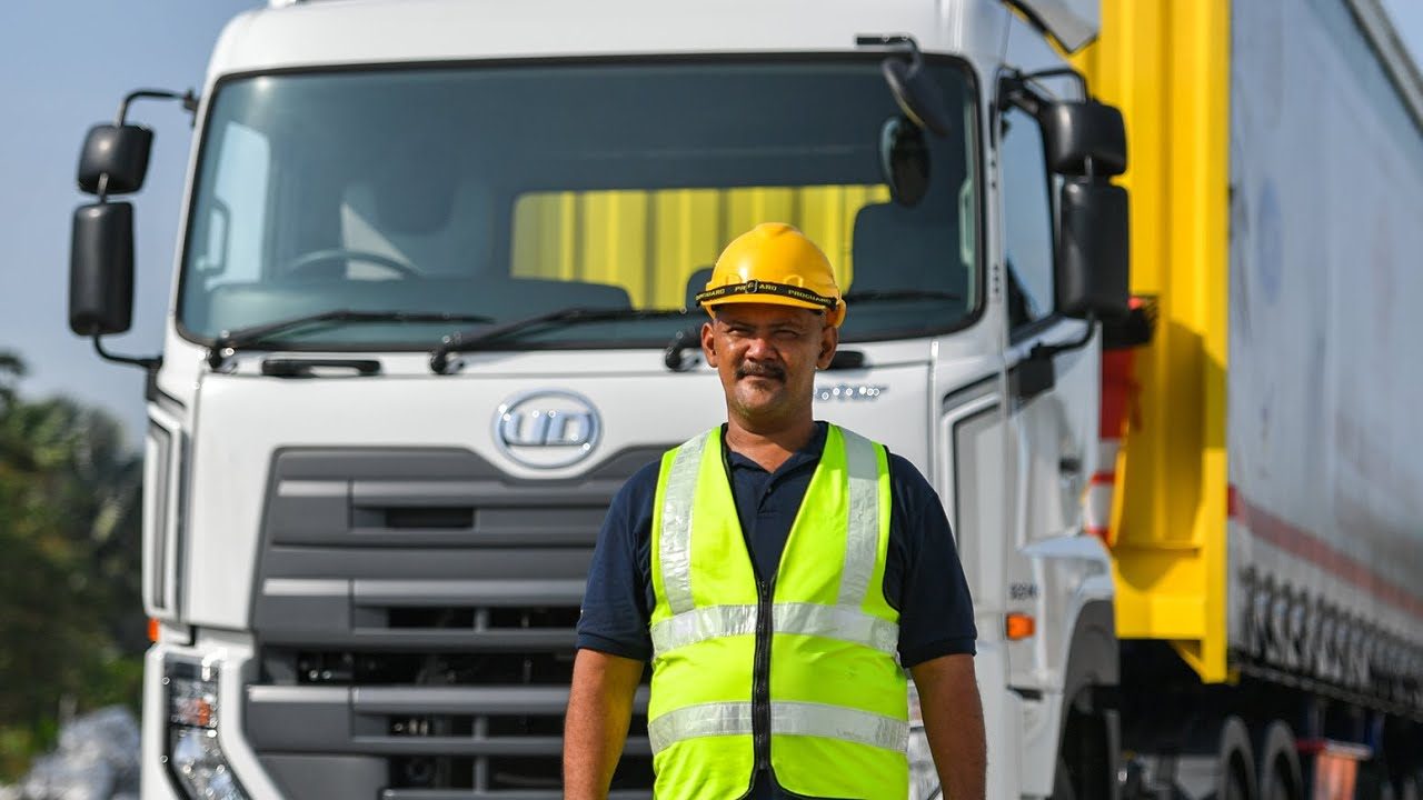 Driver in front of a logistics truck