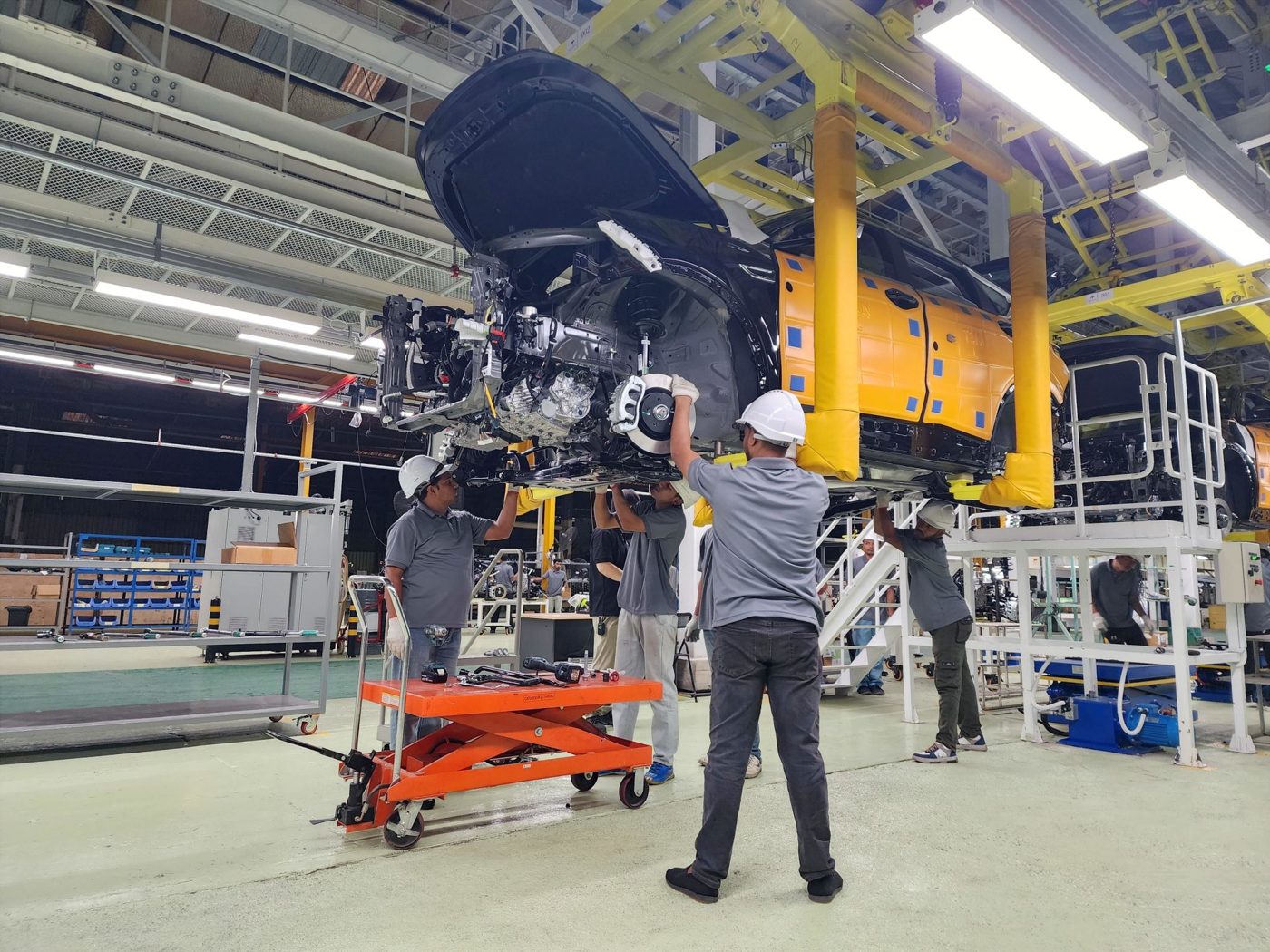 Workers on an automotive assembly line